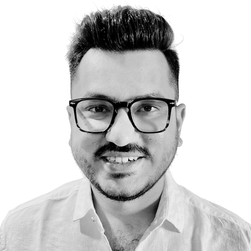 Smiling male bookkeeper with styled short black hair and glasses.