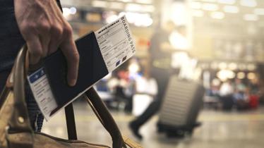 Physical Presence Test requirements illustrated by traveler with boarding pass and luggage