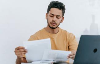 Man reviewing financial documents for FinCEN BOI reporting requirements