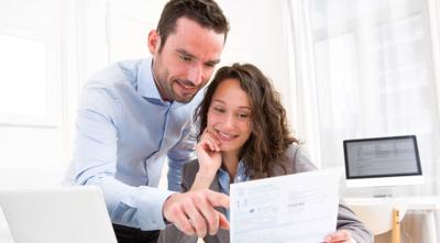 Guide for US expats on avoiding double taxation with couple doing paperwork