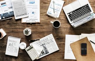 Non-US owner researching US business entity requirements with laptop and documents