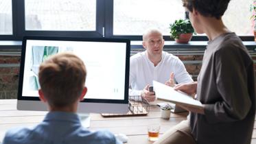 IRS Form 5471 discussion for foreign business owners in a team meeting