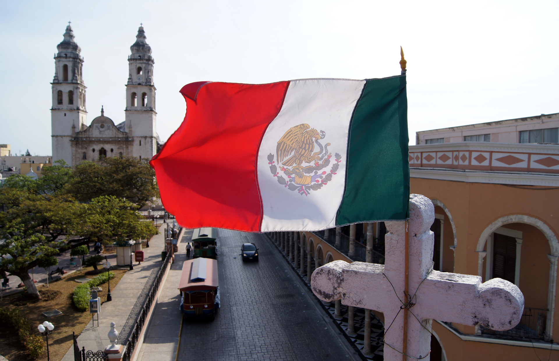 Mexican flag over a street in Mexico